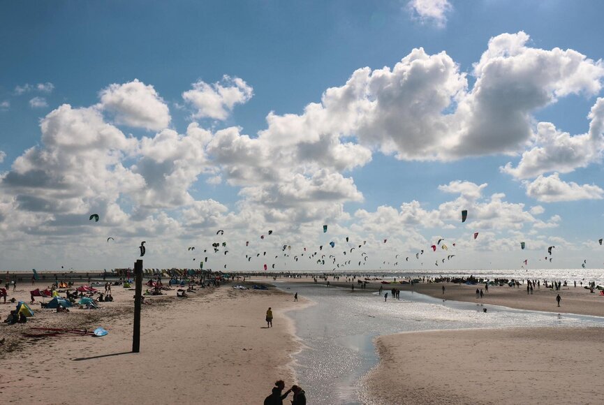 Blick über den Strand mit hunderten Kitesurfern